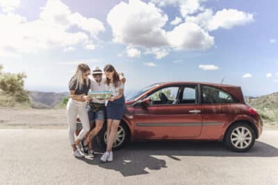 Llantas de Verano - 3 amigos frente a un auto en calor